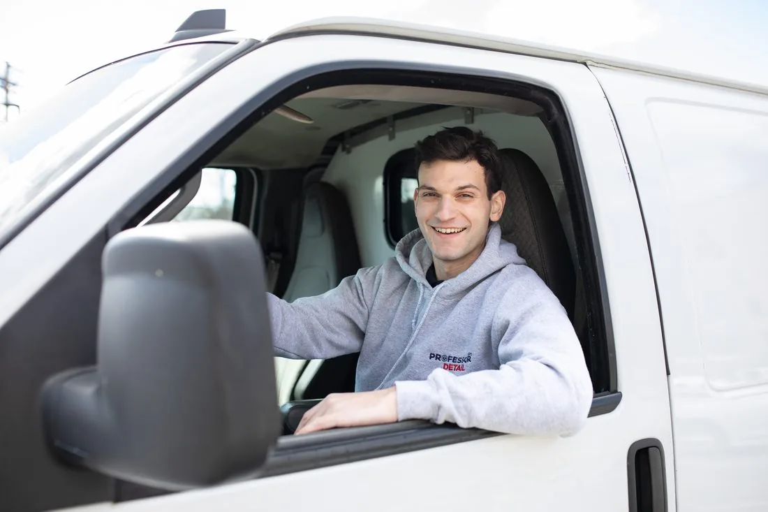 Peter Rossi smiling from the driver's seat of the Professor Detail van
