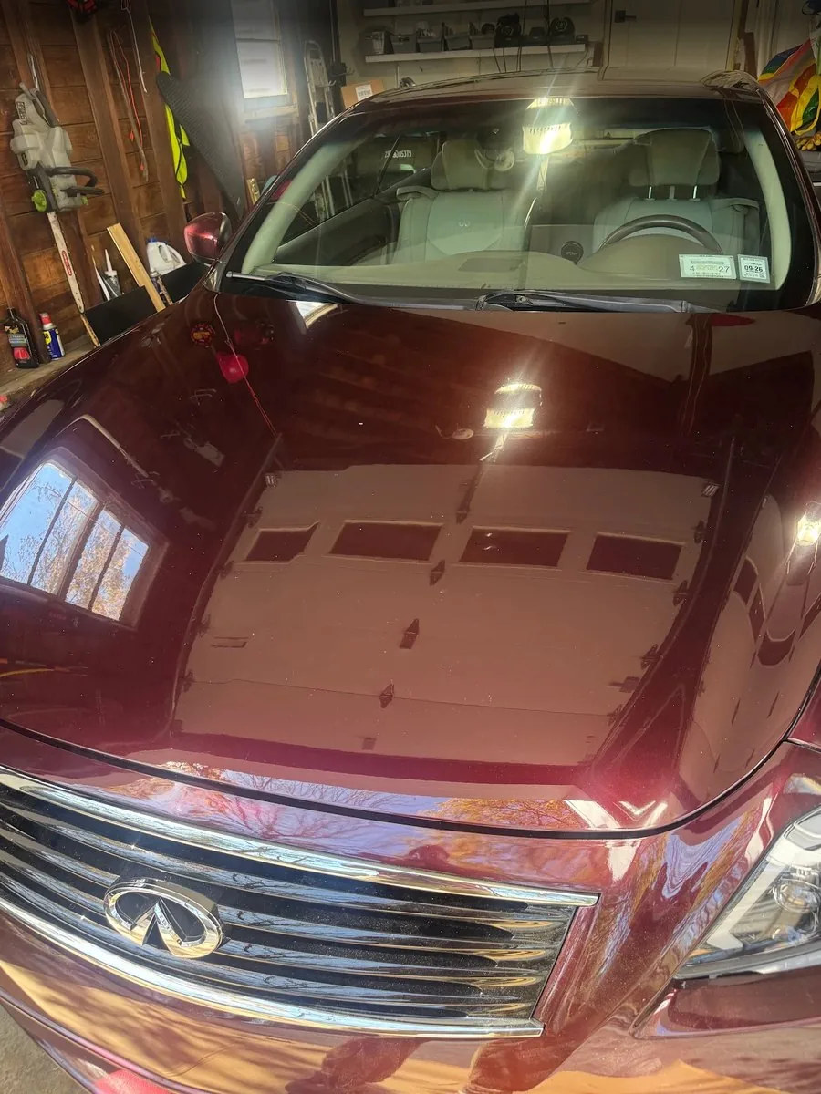 Maroon Infiniti hood after paint correction with clearer reflections
